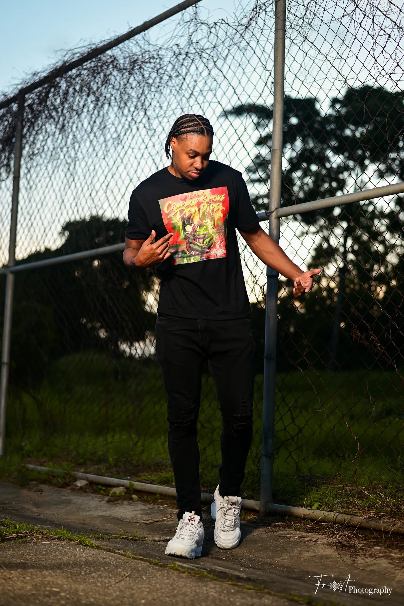 HAMZXL standing by a chain-link fence.